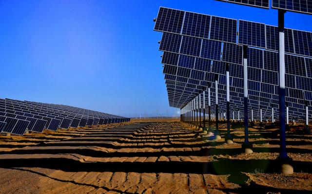 Person standing in a factory with machinery in the background