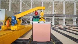 Person standing in a factory with machinery in the background